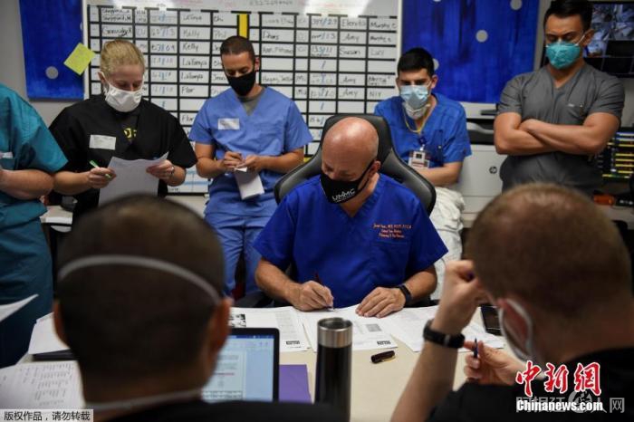 资料图:美国联合纪念医疗中心的首席医疗官约瑟夫和他的医护人员团队在每日例会上查看新冠病毒感染者的档案。 资料图:美国联合纪念医疗中心的首席医疗官约瑟夫和他的医护人员团队在每日例会上查看新冠病毒感染者的档案。