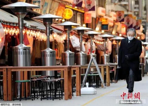 当地时间1月7日，日本东京，一名路人路过空荡的户外餐馆。1月8日0时起，日本首都圈的一都三县(东京都、埼玉县、千叶县和神奈川县)进入紧急状态，结束时间为2月7日。